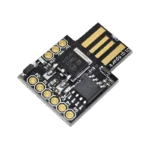 Ultra-compact blue rectangular Digispark ATtiny85 development board, highlighting its female Micro-USB port on the left, central surface-mounted ATtiny85 processor chip, a tiny 5V regulator, and solder-ready connection pads labeled P0 through P5, 5V, GND, and VIN.