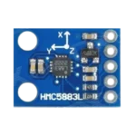 Ultra-compact blue GY-273 printed circuit board showing a tiny 3-axis magnetometer chip, decoupling capacitors, pulling resistors, and 5 parallel solder pads for pin headers.