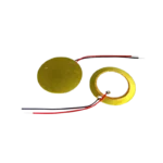 Circular 20mm piezoelectric element disc displaying its gold-colored flat brass base ring supporting a concentric inner circle coated in a matte white ceramic composition layer.