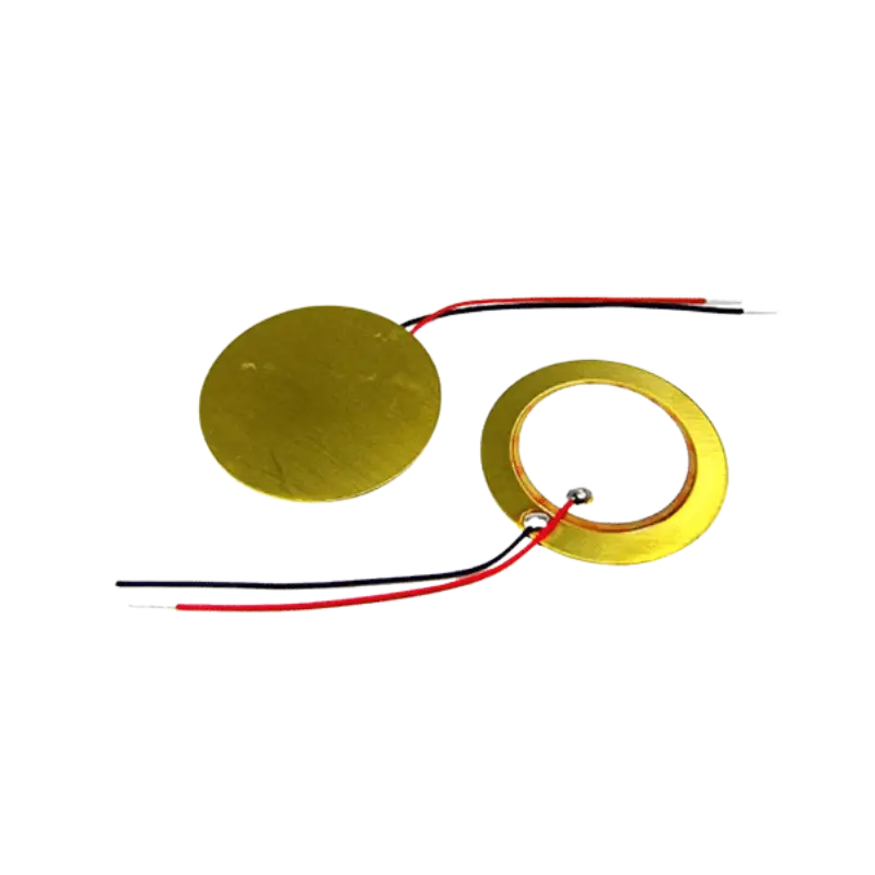 Piezo Sensor Element 20mm Circular 20mm piezoelectric element disc displaying its gold-colored flat brass base ring supporting a concentric inner circle coated in a matte white ceramic composition layer.