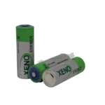 Xeno Energy XL-100F 3.6V A-size industrial primary lithium thionyl chloride battery on a solid workspace backdrop.