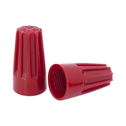 An assortment of multi-colored flame-retardant electrical wire nut connectors showing their ribbed outer shells and a hollow bottom revealing the interior tapered steel spring coils.