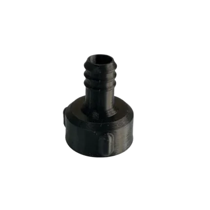 A standalone black industrial polymer water flow sensor adapter showing a 1/2-inch female threaded opening with an embedded grey sealing washer, transitioning into a ribbed barbed hose tail connection.